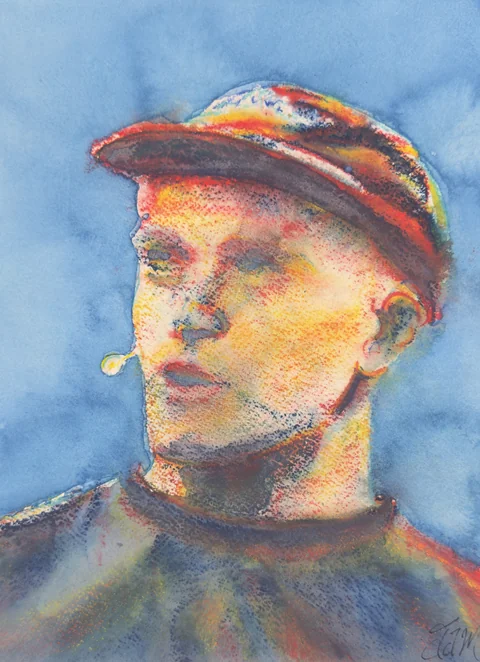 A man in a colorful cap wearing a headset microphone