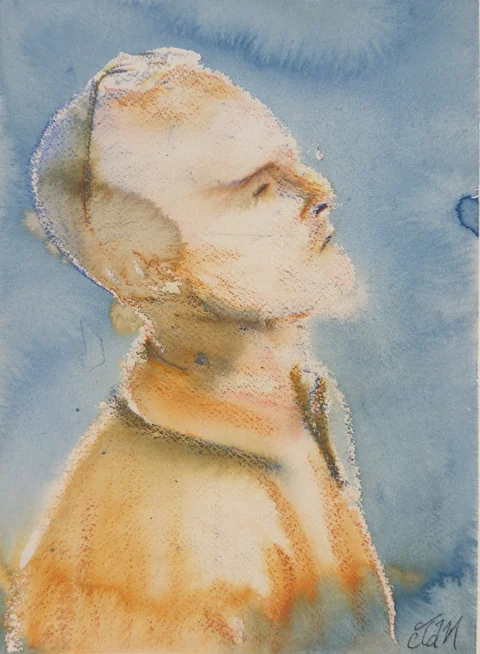 A man with close-cropped hair looking upward