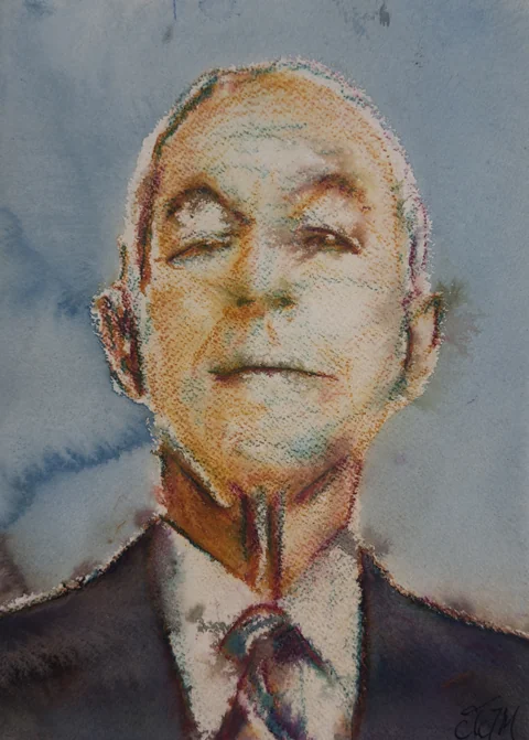 An older man in a suit and tie seen from below