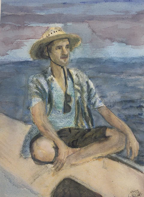 A person in a straw hat seated cross-legged on a boat
