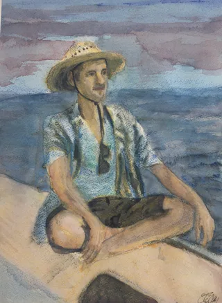A person in a straw hat seated cross-legged on a boat