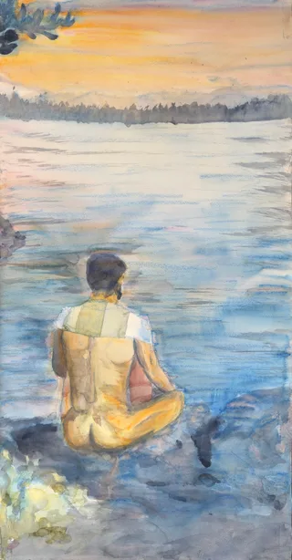 A person meditating beside a lake in golden morning light