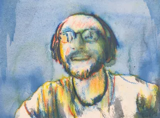 A smiling man in glasses and headphones against a blue background